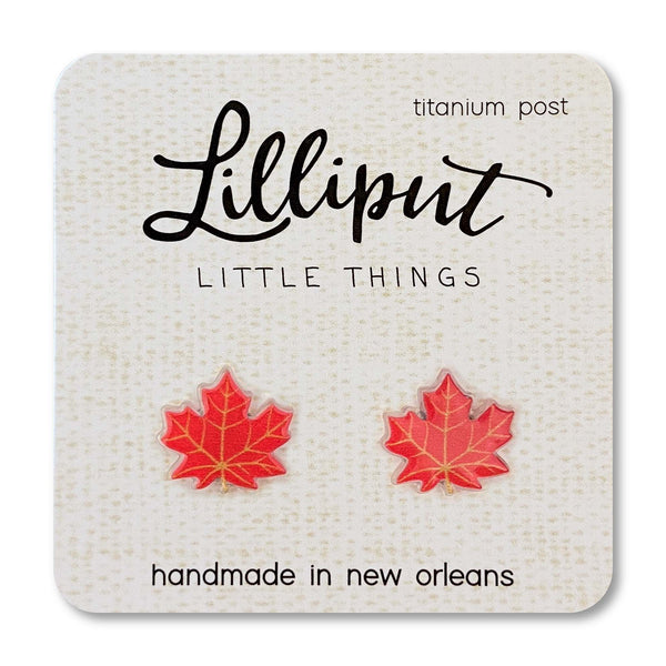Red maple leaf earrings on a Lilliput Little Things branded card.